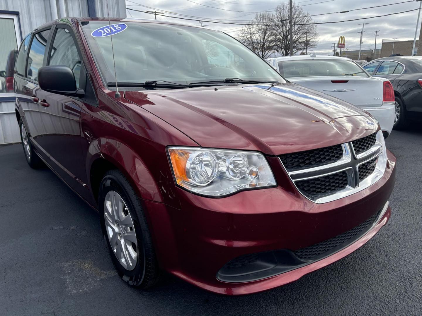 2018 RED DODGE GRAND CARAVAN SE SE (2C4RDGBG9JR) with an 3.6L V6 DOHC 24V engine, 6A transmission, located at 100 West Coliseum Boulevard, Fort Wayne, IN, 46805, (260) 471-0567, 41.119961, -85.140312 - Photo#0