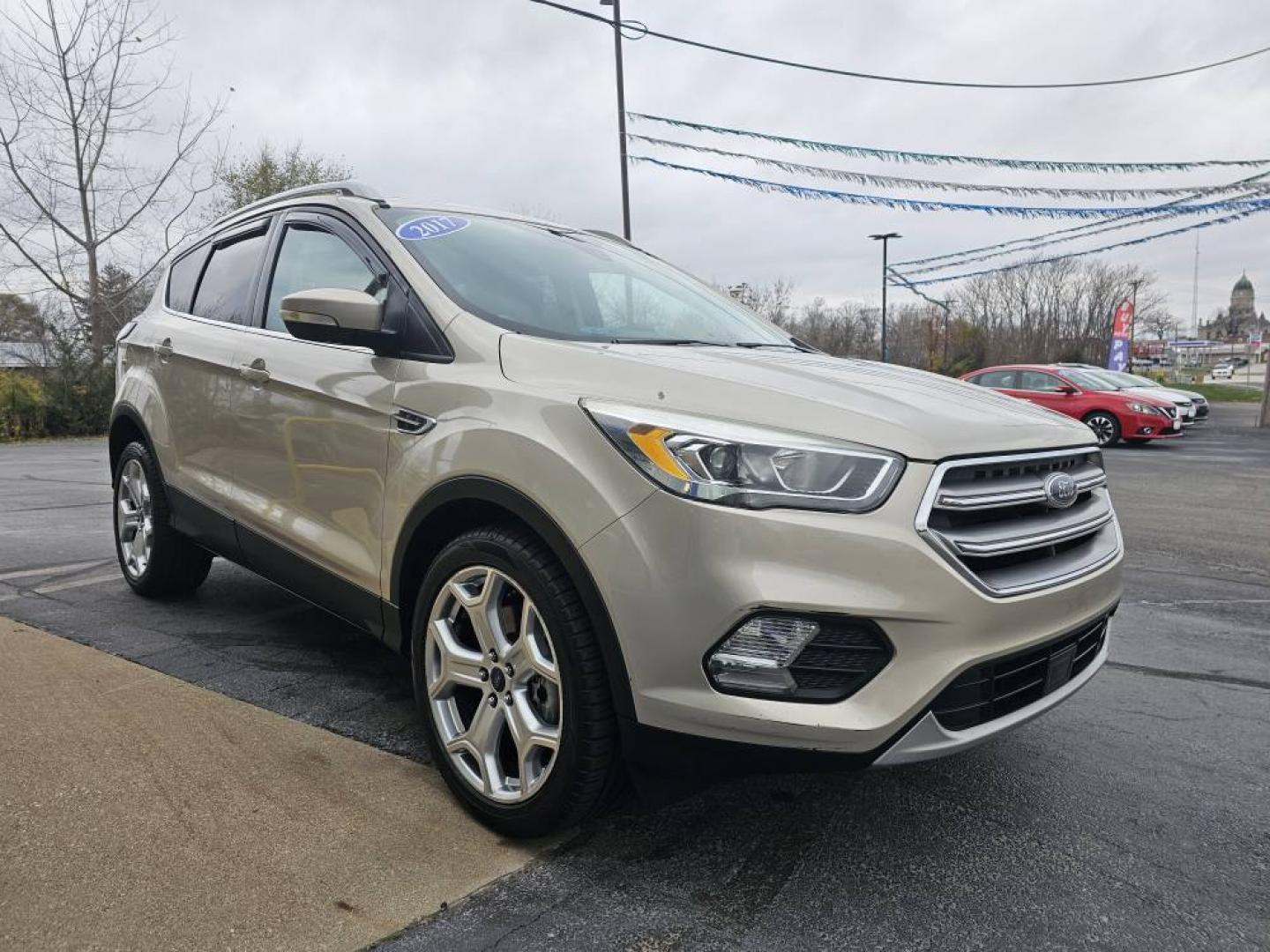 2017 GOLD /Tan FORD ESCAPE TITANIUM Titanium FWD (1FMCU0J90HU) with an 2.0L L4 DOHC 16V engine, 6A transmission, located at 502 South Main Street, Columbia City, IN, 46725, (260) 244-4645, 41.151382, -85.490578 - Photo#1